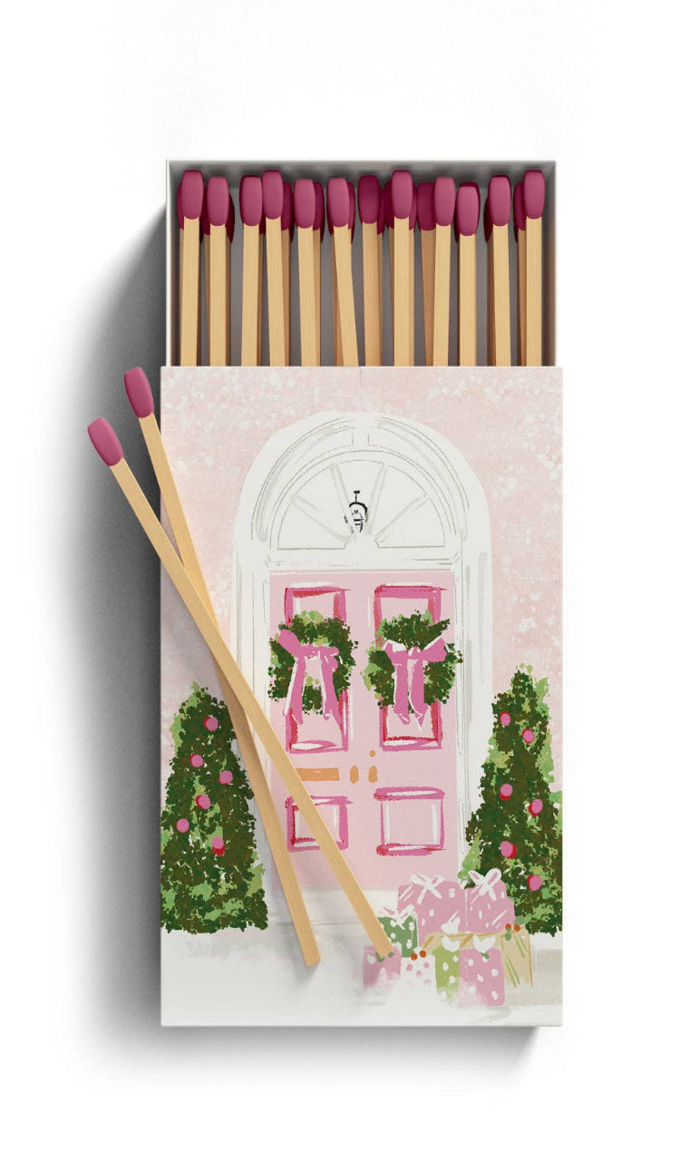 Matches with decorative packaging featuring pink and green designs on a white background